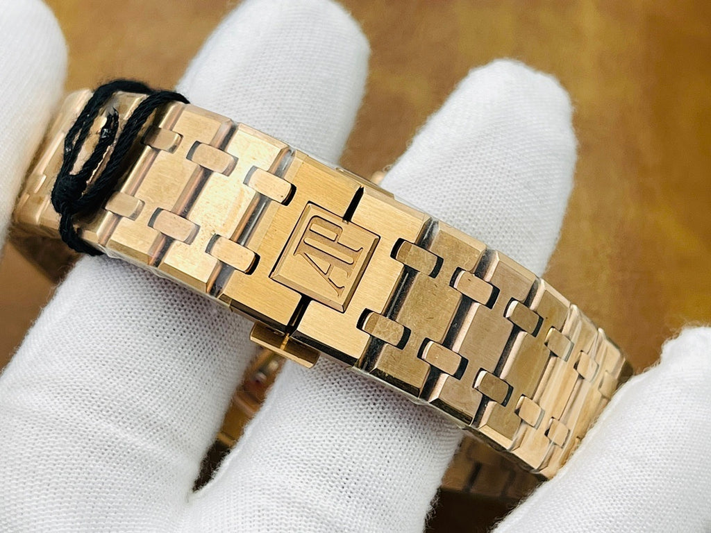Audemars Piguet watch bracelet with gold-tone metal links and secure clasp detail.
