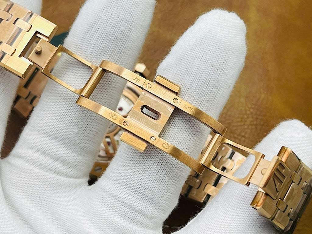 Audemars Piguet watch bracelet with gold-tone links and folding clasp close-up.