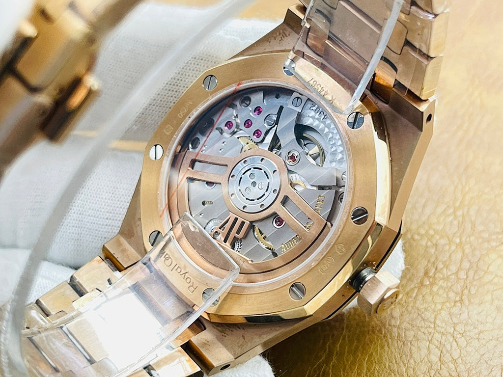 Audemars Piguet watch with exposed mechanical movement and gold-tone case bezel.