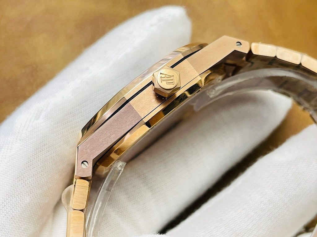 Audemars Piguet watch case side with gold-tone crown and signed emblem detail.