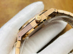 Audemars Piguet watch case side with gold-tone crown and signed emblem detail.