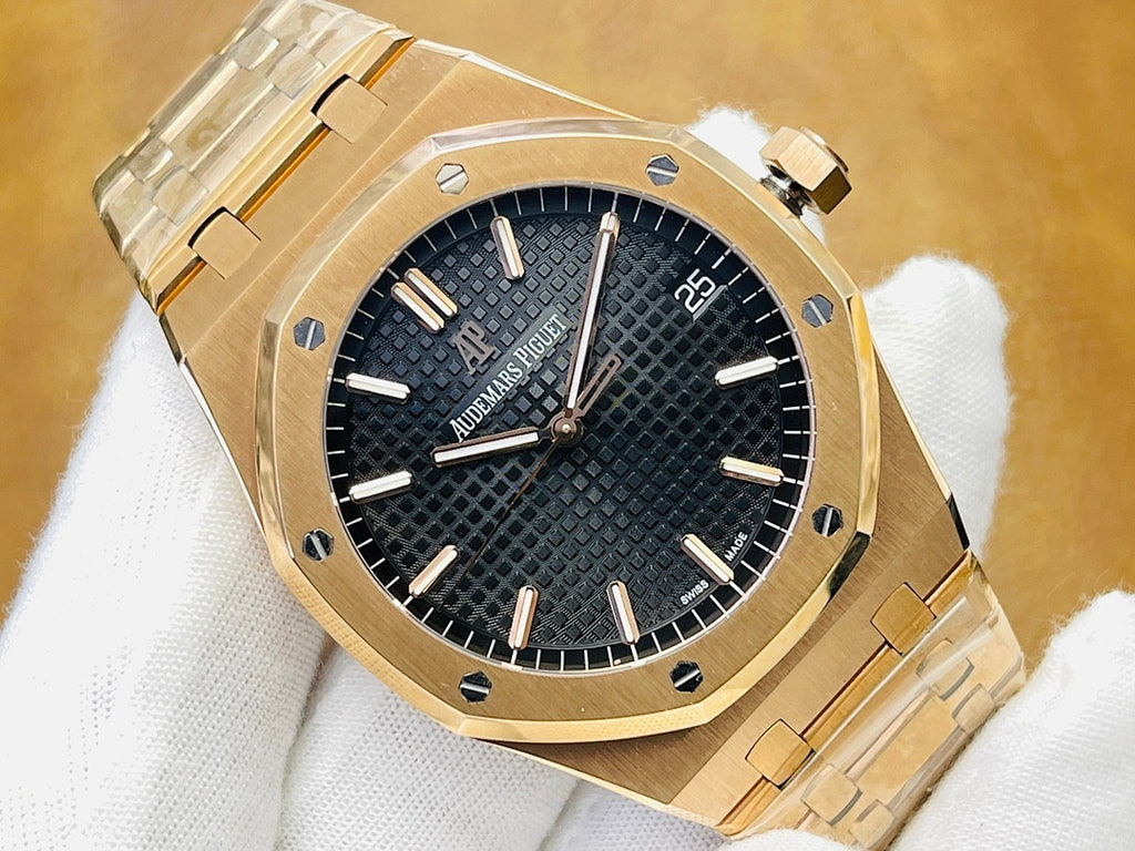 Audemars Piguet watch with black textured dial, gold-tone case and metal bracelet.