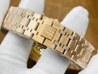 Gold-tone metal bracelet link view for a luxury wristwatch, folded on white cloth