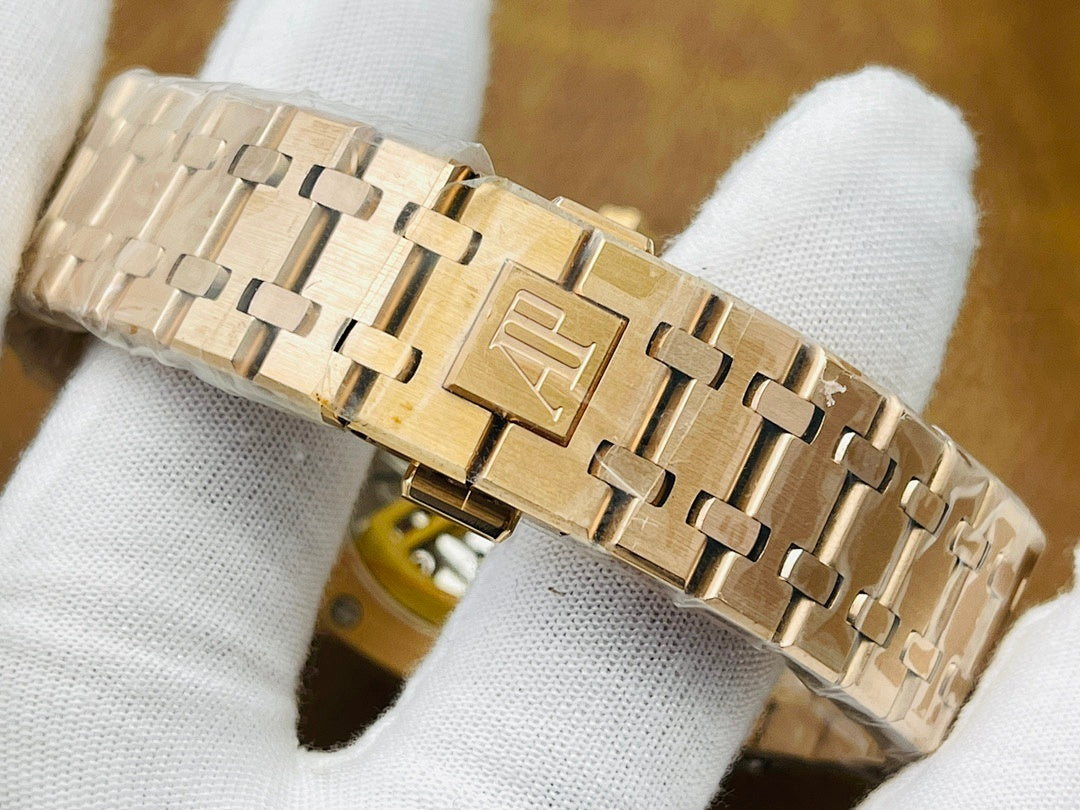 Gold-tone metal bracelet link view for a luxury wristwatch, folded on white cloth