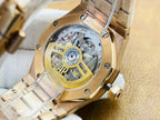 Open-view luxury wristwatch with gold-tone movement visible through clear caseback