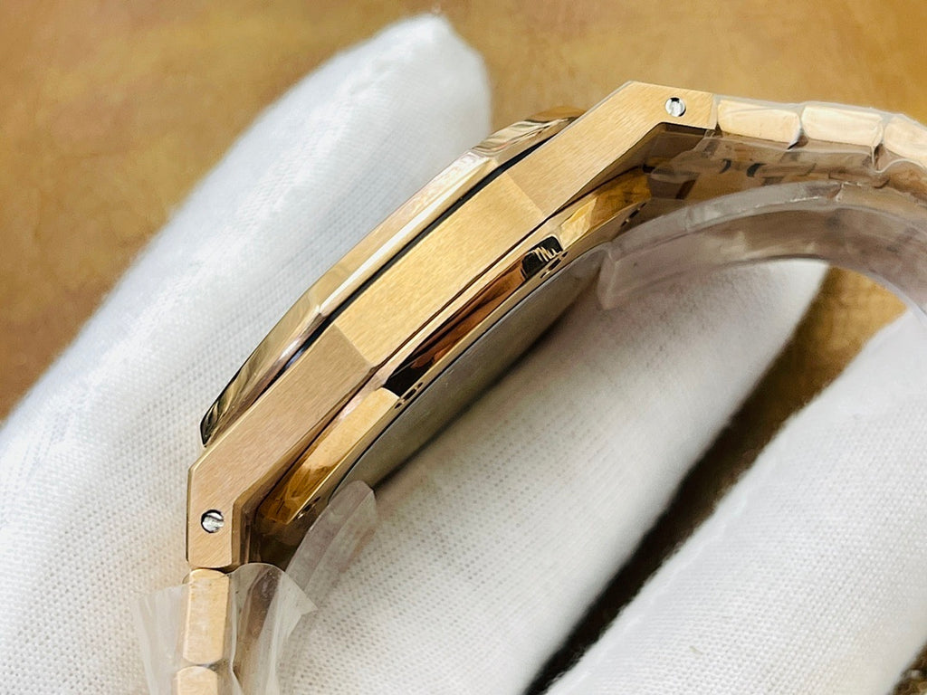Gold-tone wristwatch case side profile with metal bracelet on white cloth