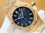 Gold-tone luxury watch with dark blue textured dial, baton markers, and crown