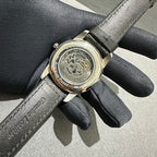 Audemars Piguet watch caseback on black fabric strap with visible mechanical movement