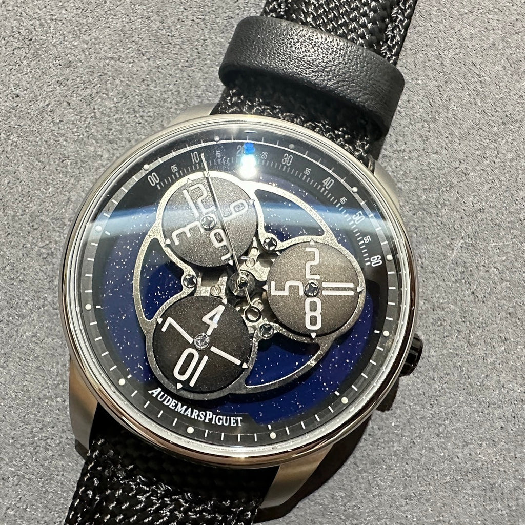Audemars Piguet watch with blue patterned skeleton dial, black textured strap