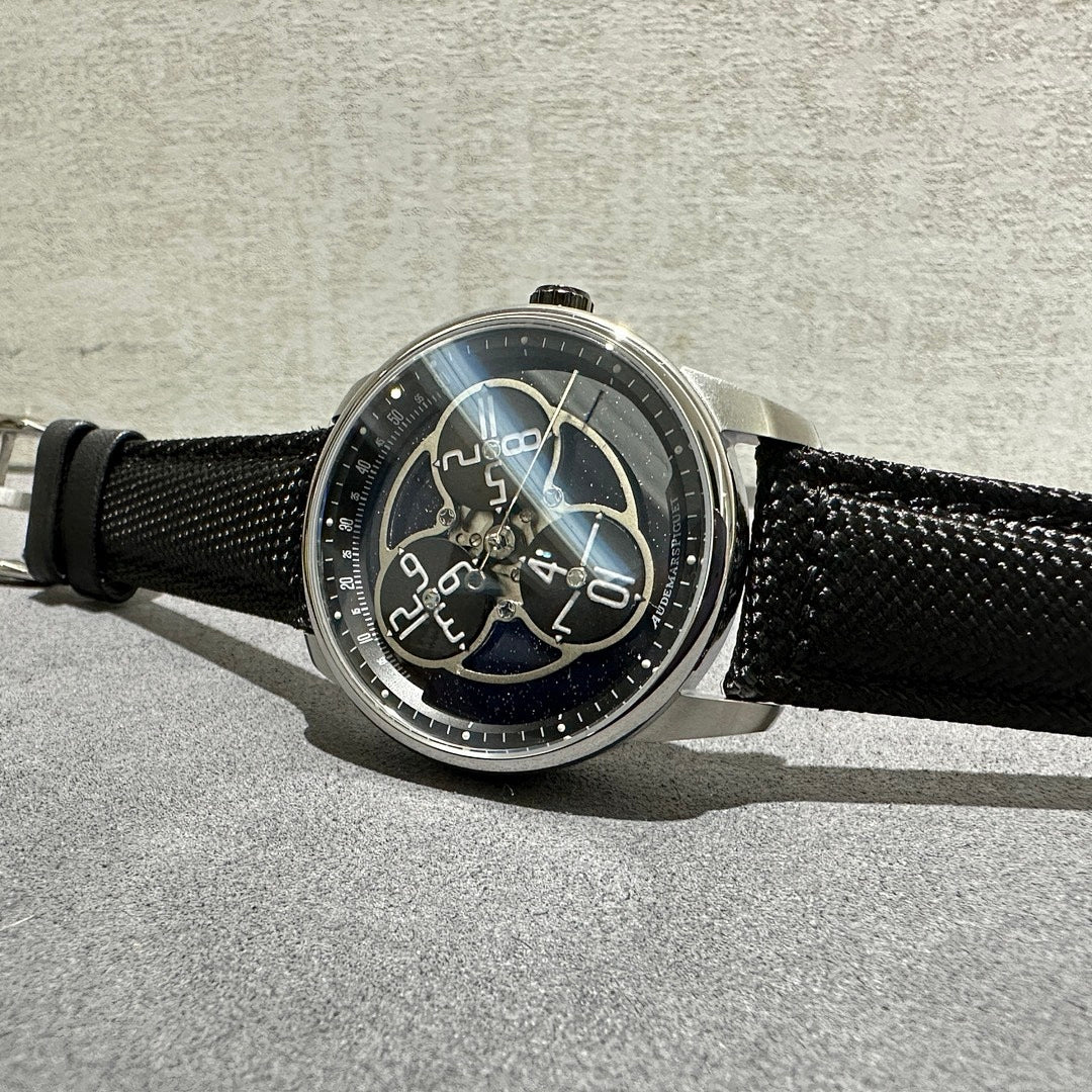 Audemars Piguet watch on black textured strap, silver case with visible crown