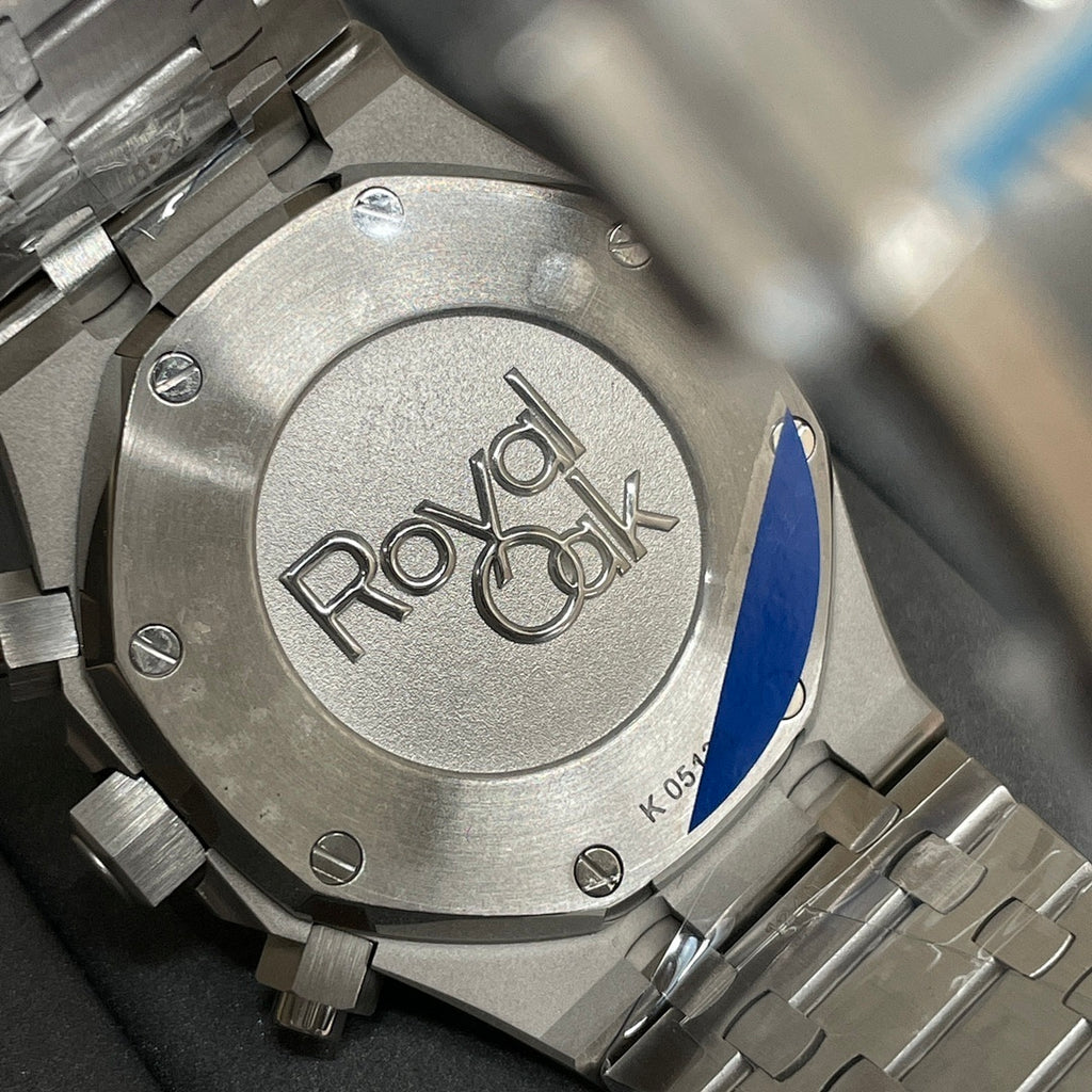 Audemars Piguet watch caseback in brushed steel with engraved logo and screw details