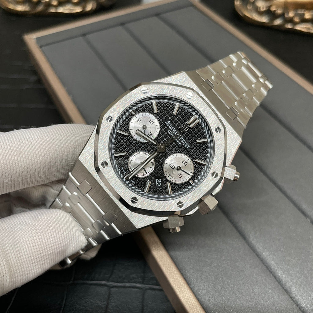 Audemars Piguet chronograph watch at 3/4 angle, black dial with subdials and steel bracelet