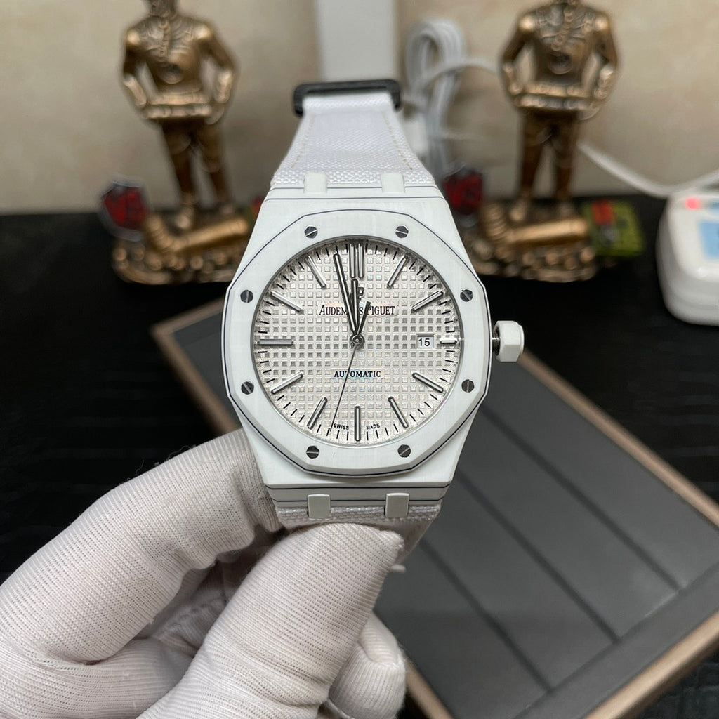 Audemars Piguet Royal Oak watch held in hand, silver dial and white strap