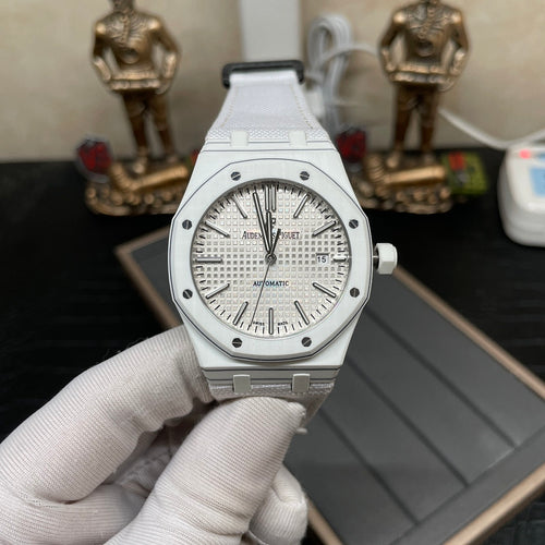Audemars Piguet Royal Oak watch held in hand, silver dial and white strap