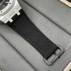 Audemars Piguet wristwatch strap close-up with black woven fabric and metal buckle