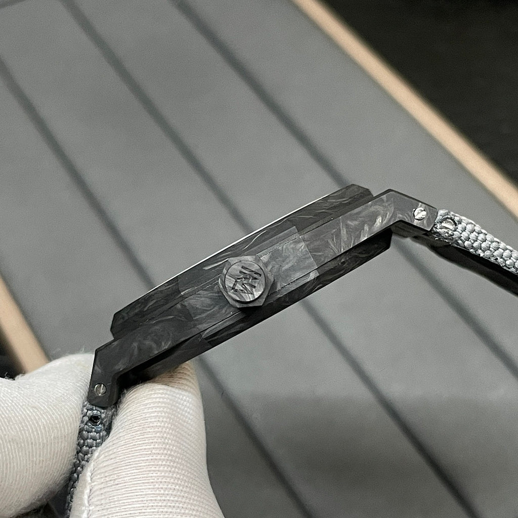 Audemars Piguet watch case edge close-up with black textured strap and clasp