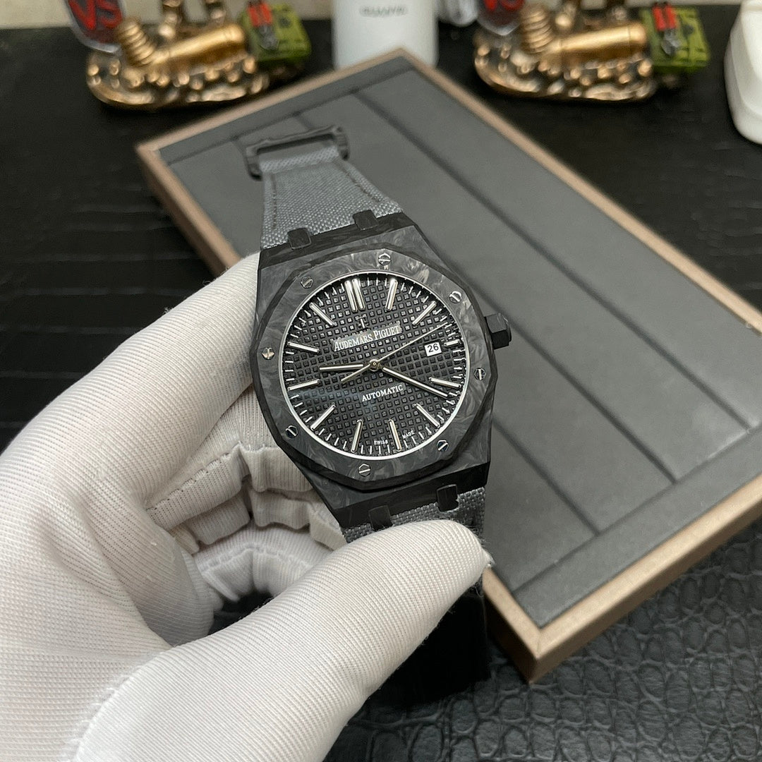 Audemars Piguet watch with black dial and date window, black strap in open box