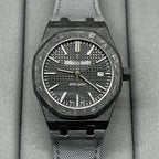 Audemars Piguet watch with black textured dial, date window at 3, black mesh strap