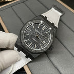 Audemars Piguet automatic watch with black textured dial and white strap, close-up