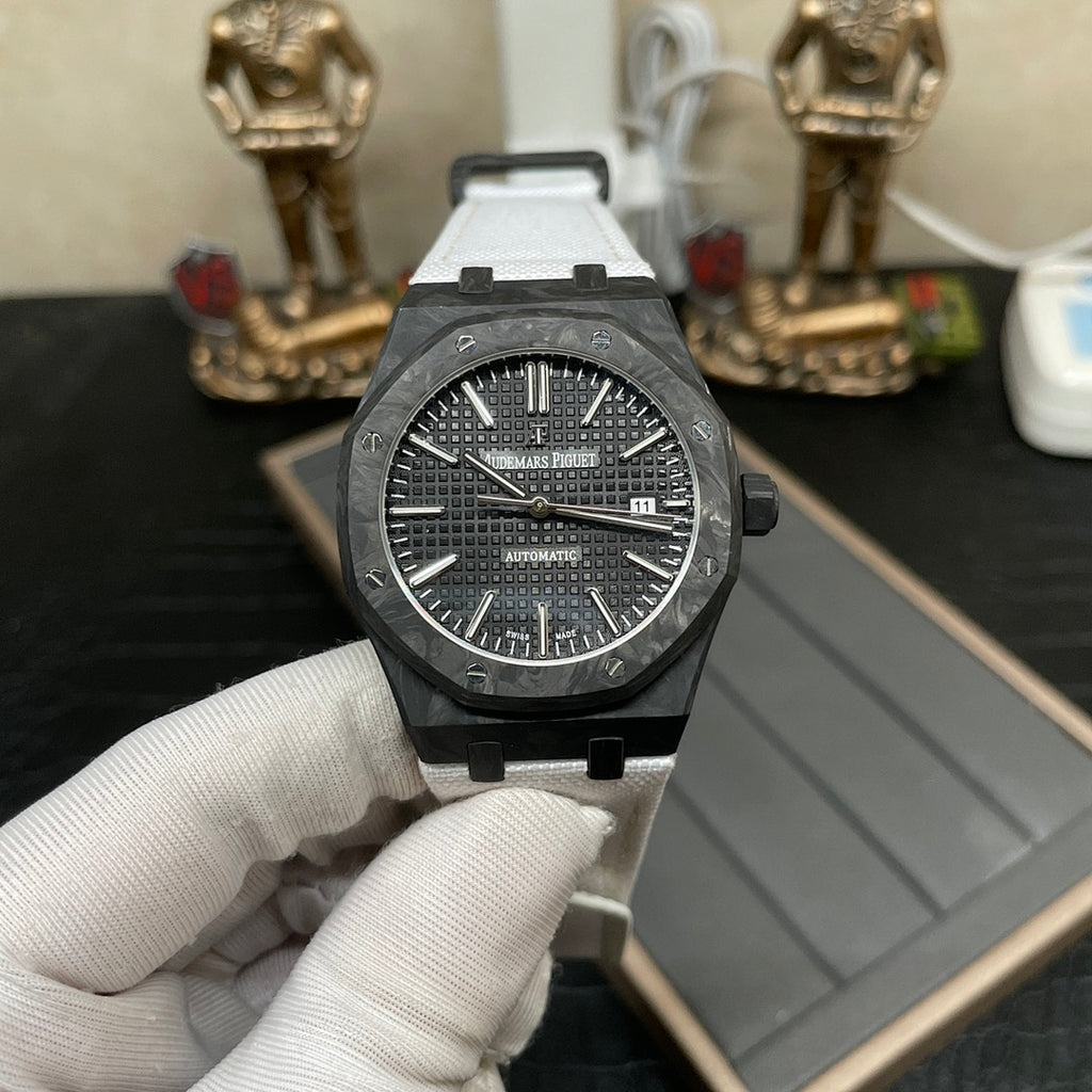 Audemars Piguet automatic watch with black dial and white strap on display tray
