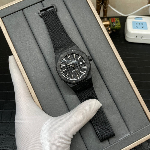 Audemars Piguet black sports watch with woven strap and patterned black dial