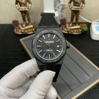 Audemars Piguet black sports watch with patterned dial and date at 3