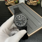 Audemars Piguet black sports watch angled view with textured dial and date window