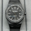 Audemars Piguet black sports watch with textured dial and date window