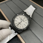 Audemars Piguet Royal Oak watch with white dial, black case, and white fabric strap
