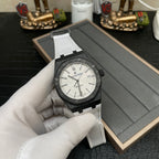 Audemars Piguet Royal Oak watch with white dial, black case, and white strap in display