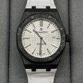 Audemars Piguet Royal Oak watch with black octagonal case, white dial, and white strap
