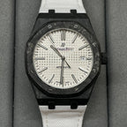 Audemars Piguet Royal Oak watch with black octagonal case, white dial, and white strap