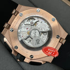 Rose gold watch caseback with visible mechanical movement and black rubber strap