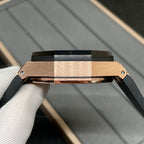 Rose gold watch case with black strap and crown, shown in side profile