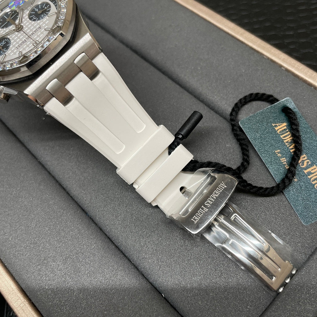 Luxury wristwatch with white ceramic strap and silver case, side view