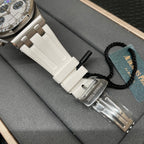 Luxury wristwatch with white ceramic strap and silver case, side view