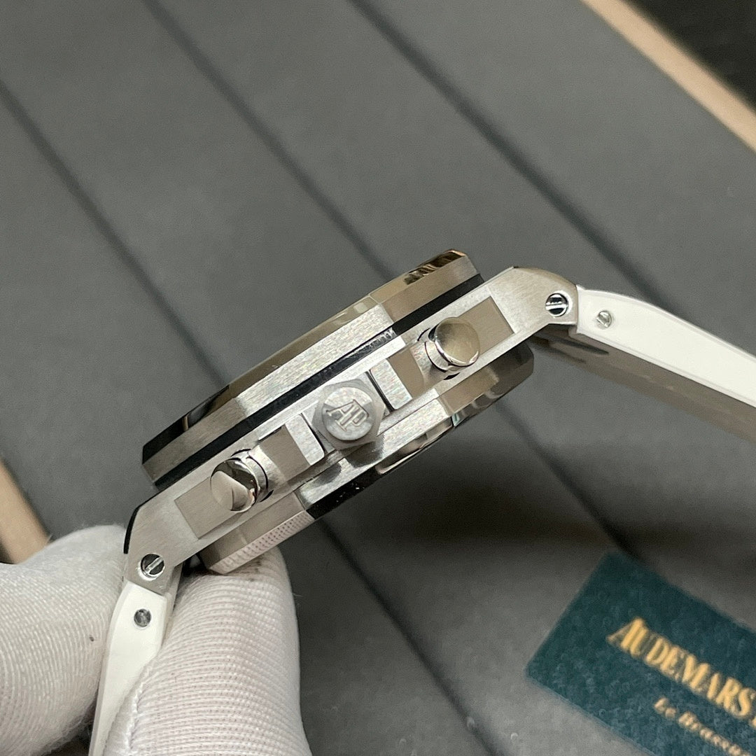 Luxury wristwatch crown and side pushers on silver case with white strap