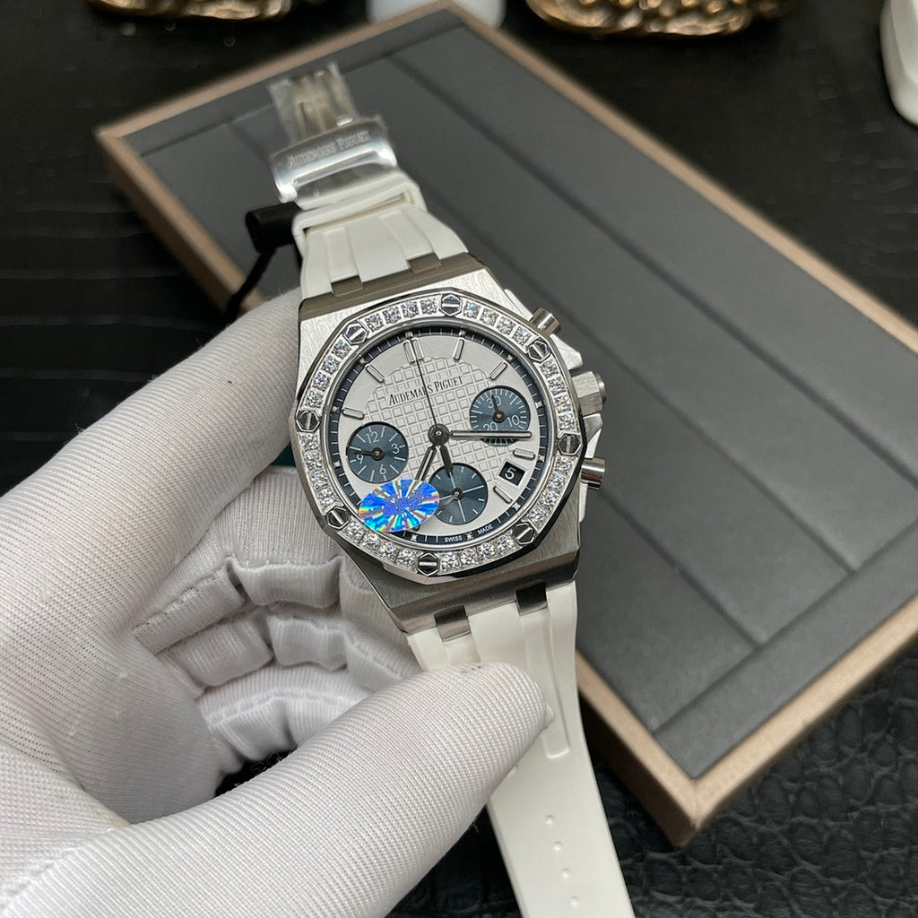 Luxury chronograph wristwatch with silver case, diamond bezel, and white ceramic strap
