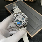 Luxury chronograph wristwatch with silver case, diamond bezel, and white ceramic strap