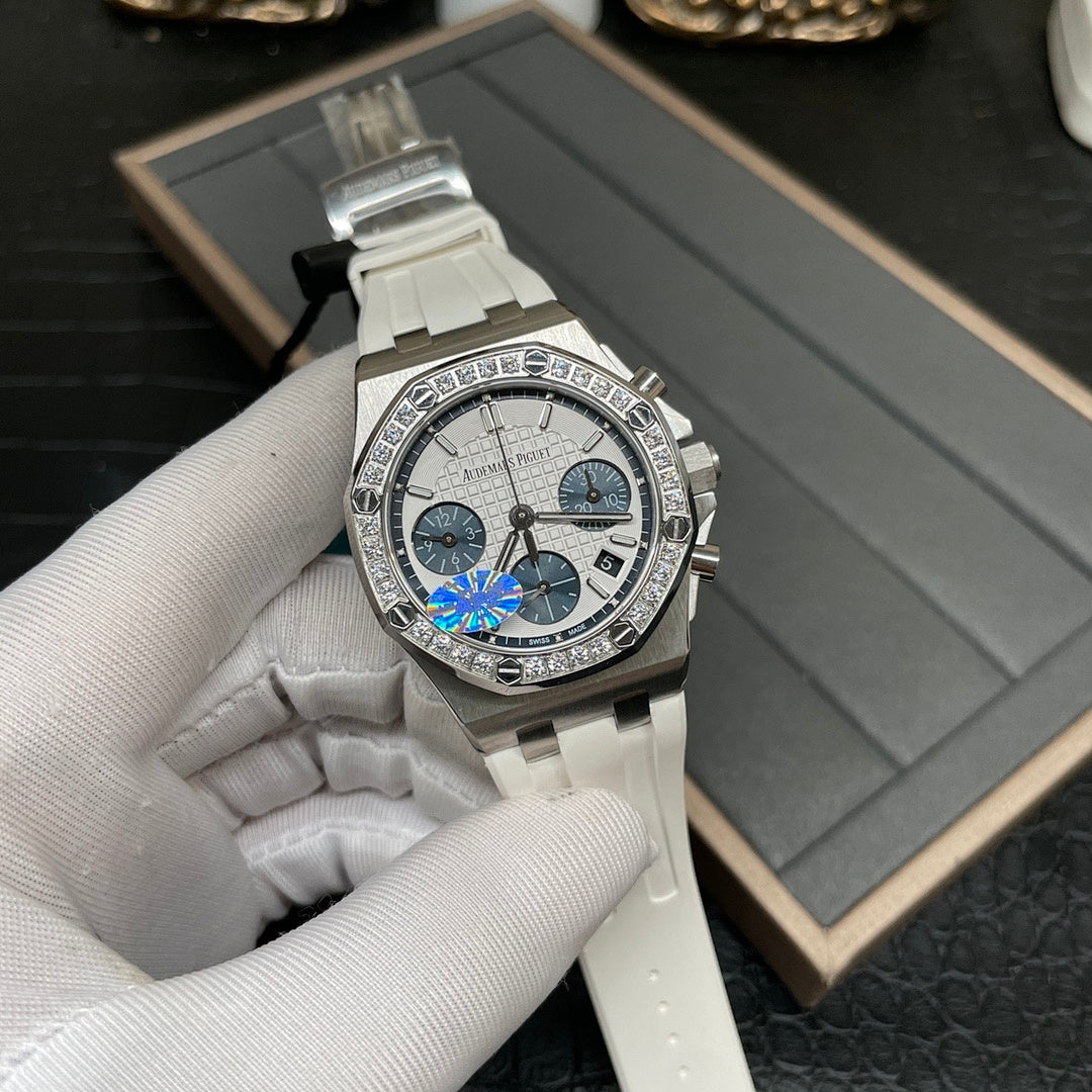 Luxury chronograph wristwatch with silver case, diamond bezel, and white ceramic strap