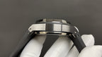 Audemars Piguet wristwatch side profile on black strap, steel case and links