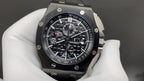 Audemars Piguet wristwatch with black dial, chronograph subdials, steel bracelet