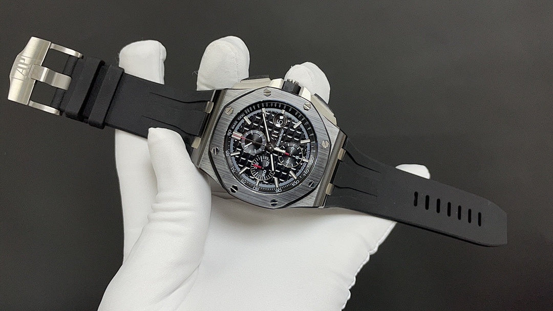 Audemars Piguet wristwatch angled view, black dial with red accents, rubber strap