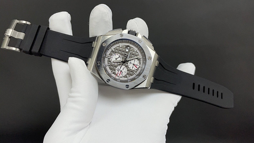 Audemars Piguet Royal Oak watch on black rubber strap, silver case with black dial