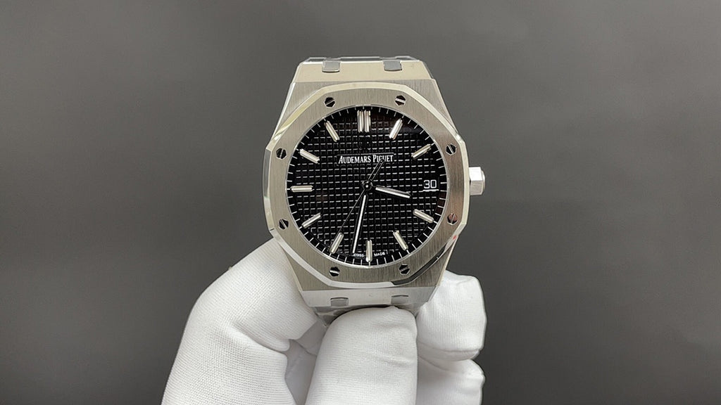 Audemars Piguet watch with black textured dial, steel octagonal case, and bracelet
