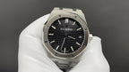 Audemars Piguet watch with black dial, baton hour markers, and steel octagonal case