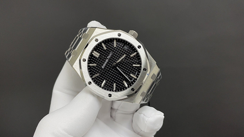 Audemars Piguet watch angled view with black dial, steel bezel, and integrated bracelet