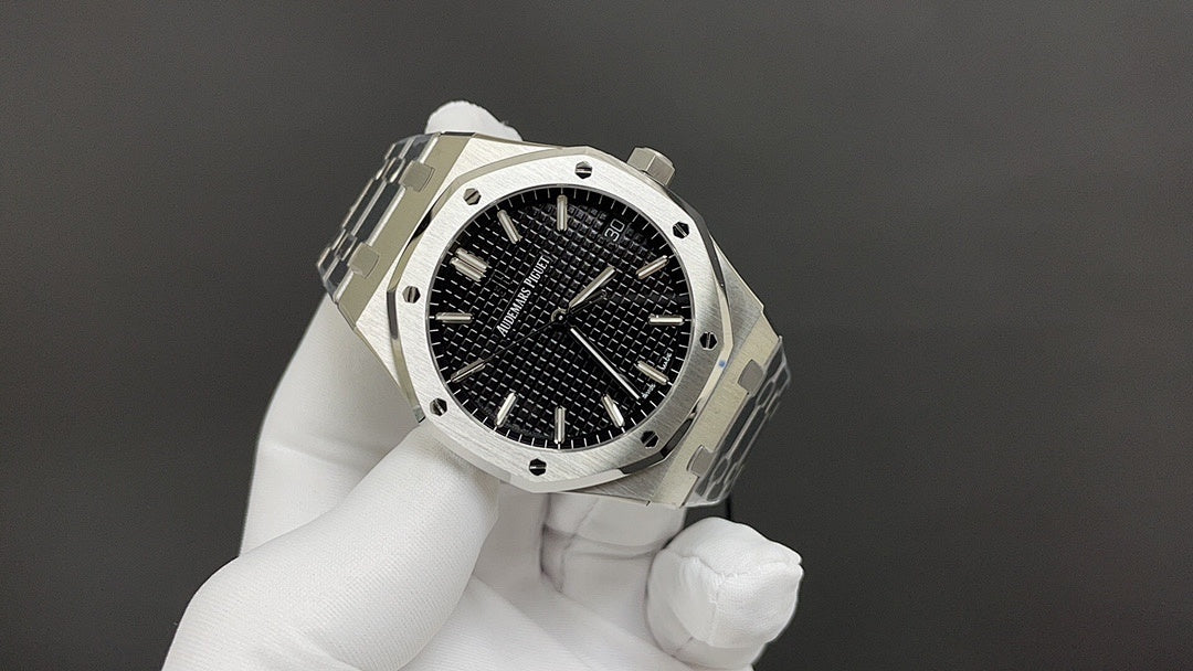 Audemars Piguet watch angled view with black dial, steel bezel, and integrated bracelet