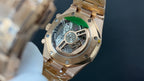 Audemars Piguet watch case with visible mechanical movement and gold-tone finish