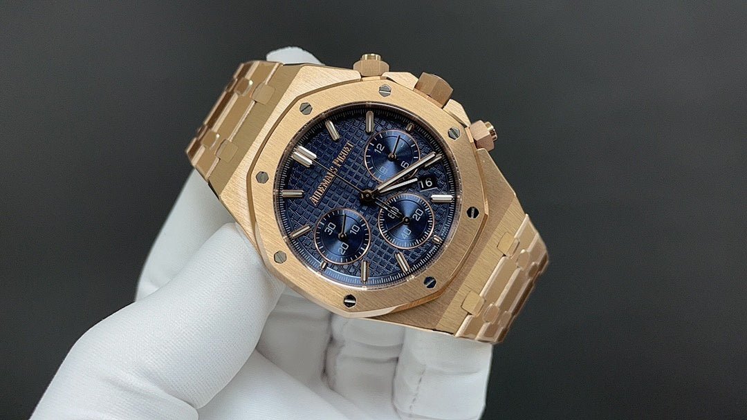 Audemars Piguet watch angled view with gold-tone bracelet and blue chronograph dial